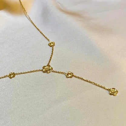 Détail du collier Y en acier inoxydable avec motifs de fleurs, pour un style délicat et élégant.